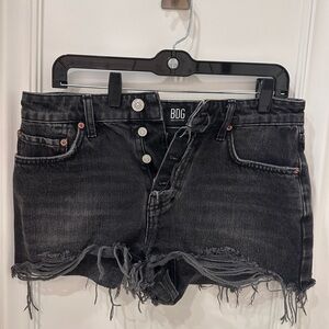 Summer cutoff black denim shorts with frayed hem -